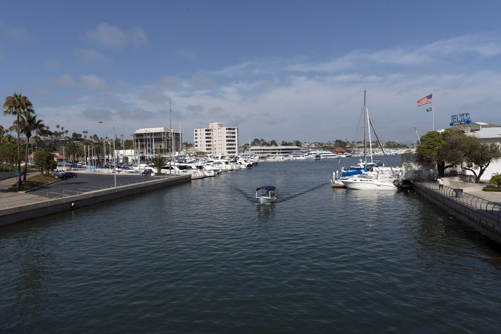 The harbor channel off Coast Highway, lined with yachts and palm trees