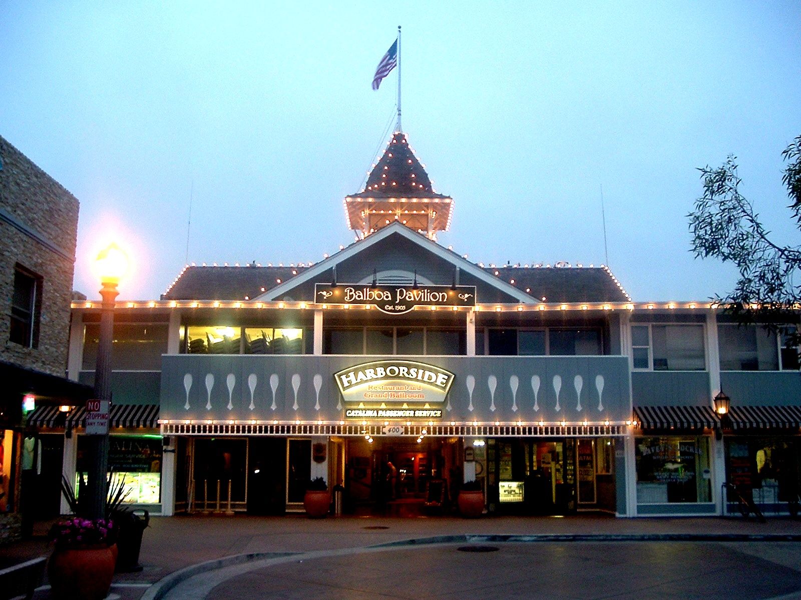 The Balboa Pavilion at dusk, lit up with the Harborside Restaurant sign