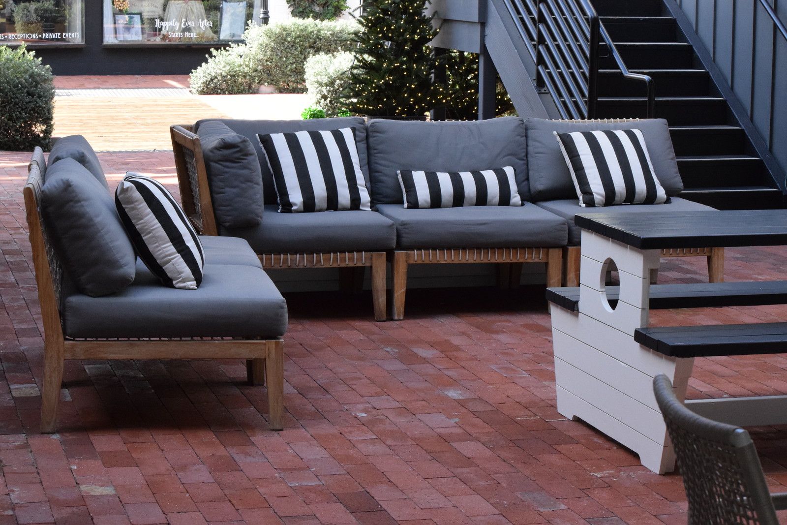 Outdoor lounge seating on the brick courtyard at Lido Marina Village