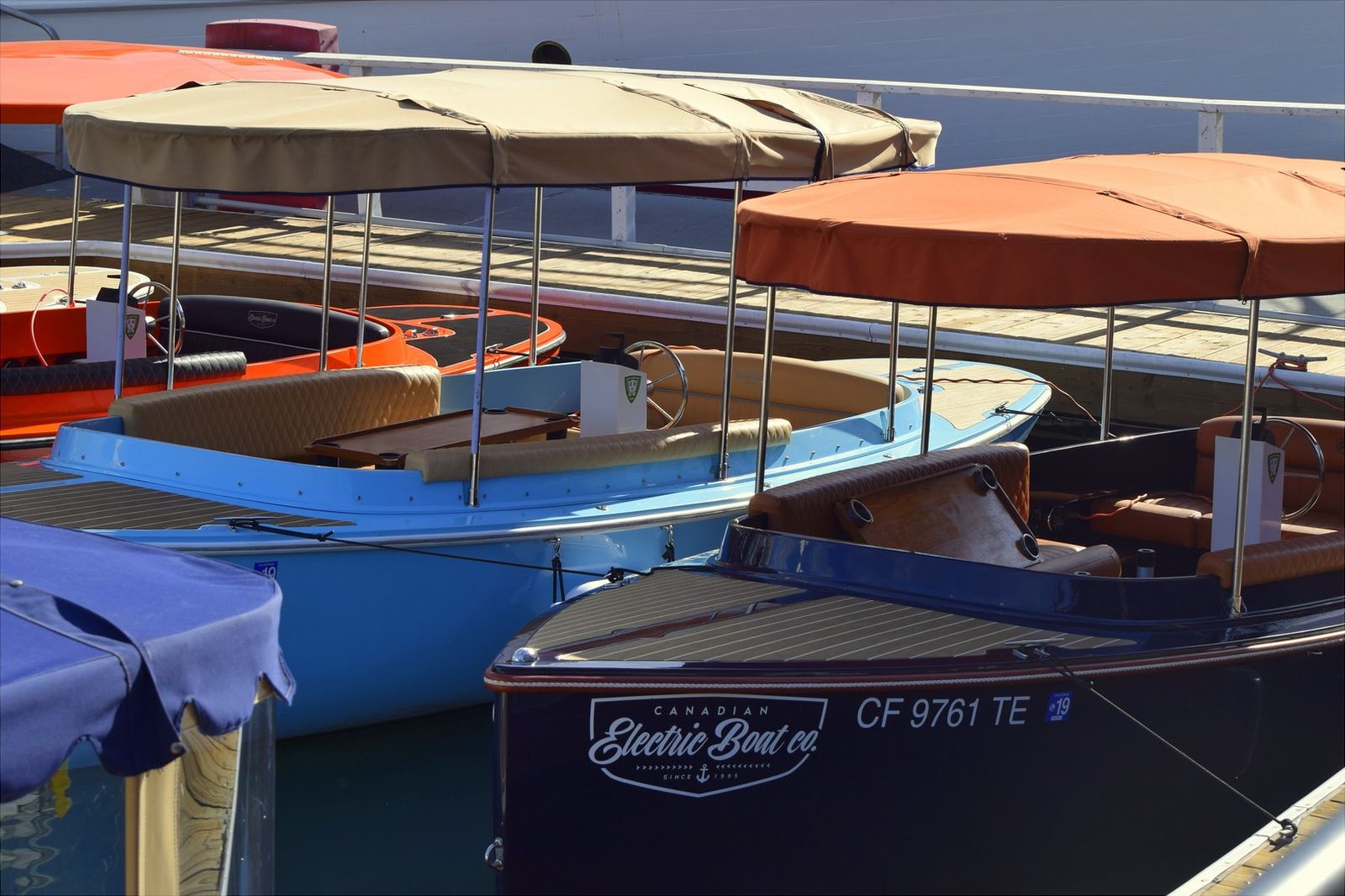 Electric Duffy boats with canopies docked at Lido Marina Village